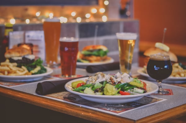 Beer and plates of food at restaurant table