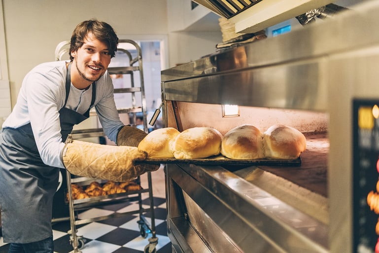 Baking using apron and oven mits for kitchen safety.jpg