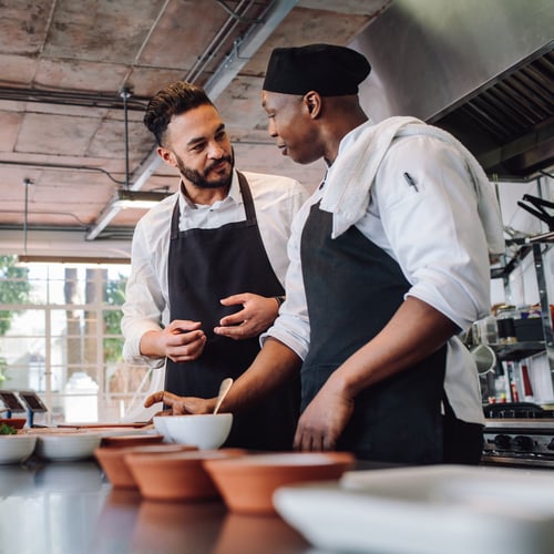 Business owner and chef working in kitchen