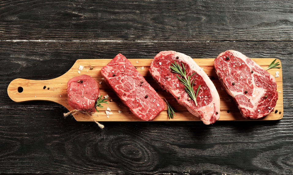 Steaks on a cutting board.