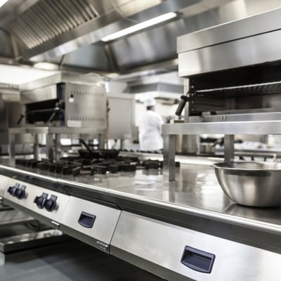 Kitchen equipment with chef in background